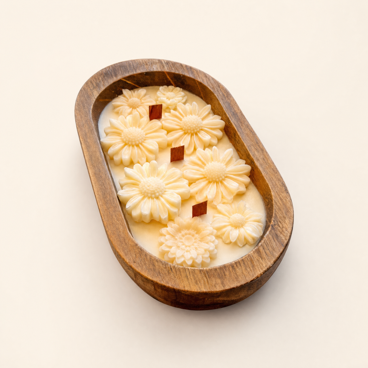 Daisy dough bowl candle with three wood wicks in an oval wooden bowl
