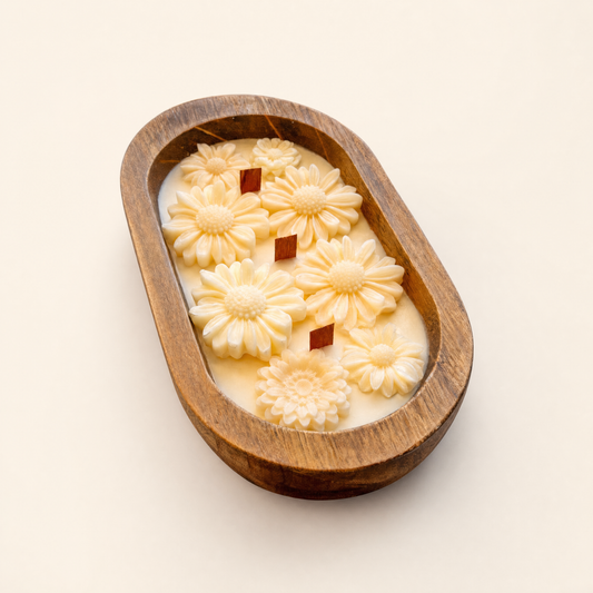 Daisy dough bowl candle with three wood wicks in an oval wooden bowl